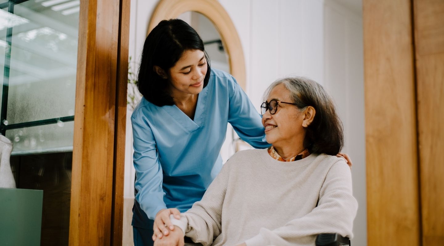 An AVet Cares caregiver preparing a meal with a senior client at home in Augusta
