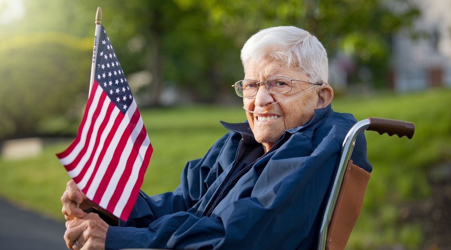 An AVet Cares caregiver helping a veteran client stand and move safely at home in Augusta