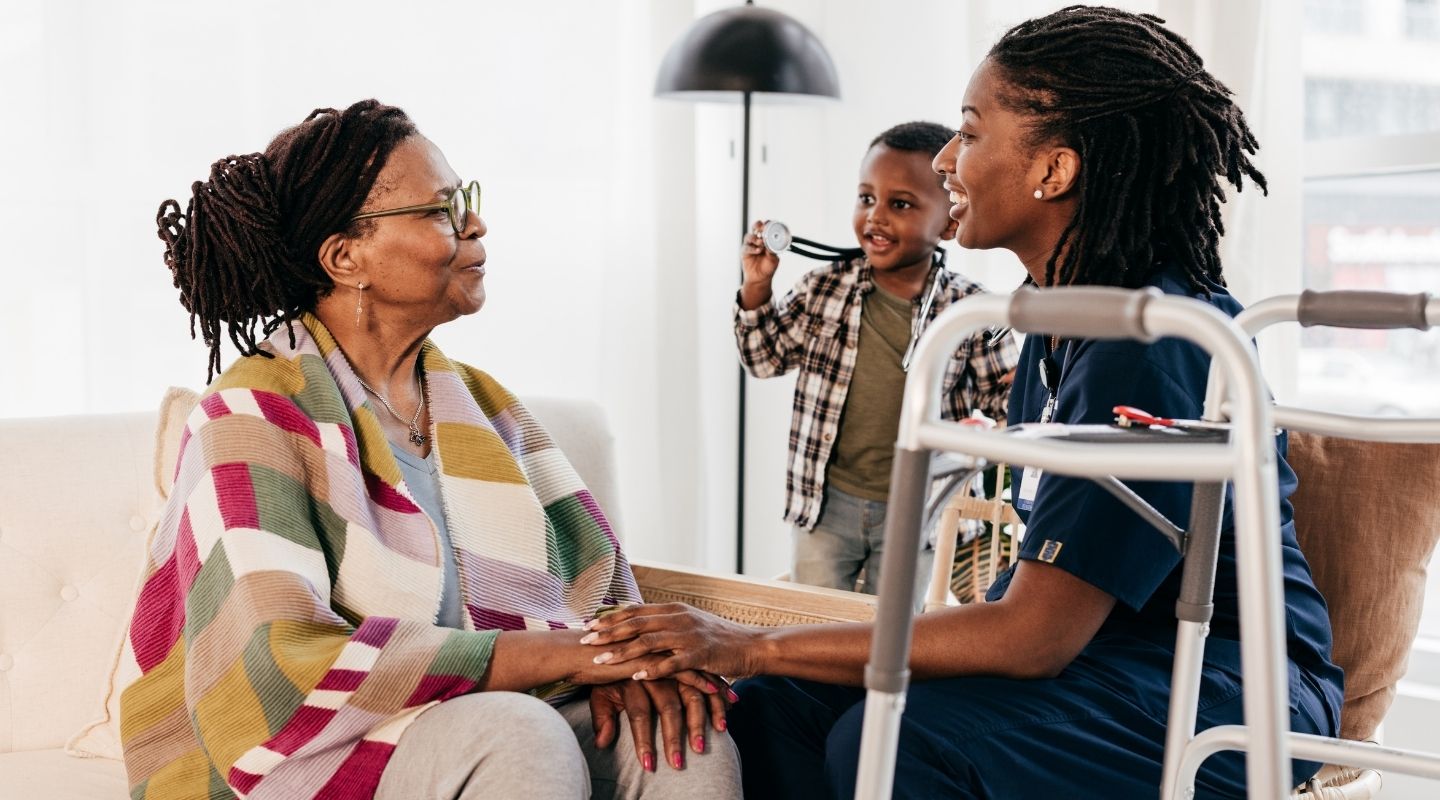 An AVet Cares caregiver sharing a warm moment with a senior client outdoors in Augusta