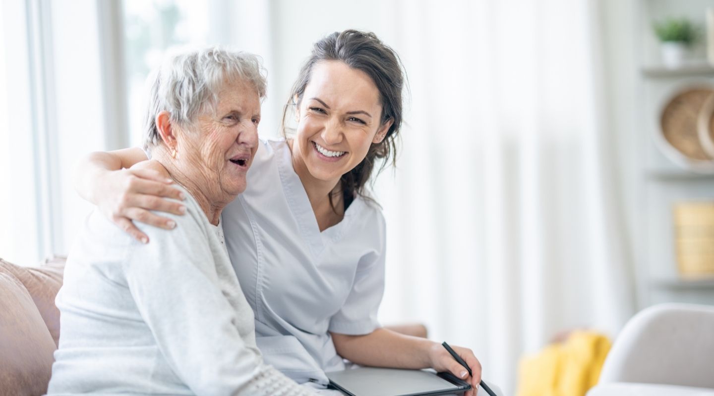 An AVet Cares caregiver holding a senior client's hands in a moment of comfort and reassurance