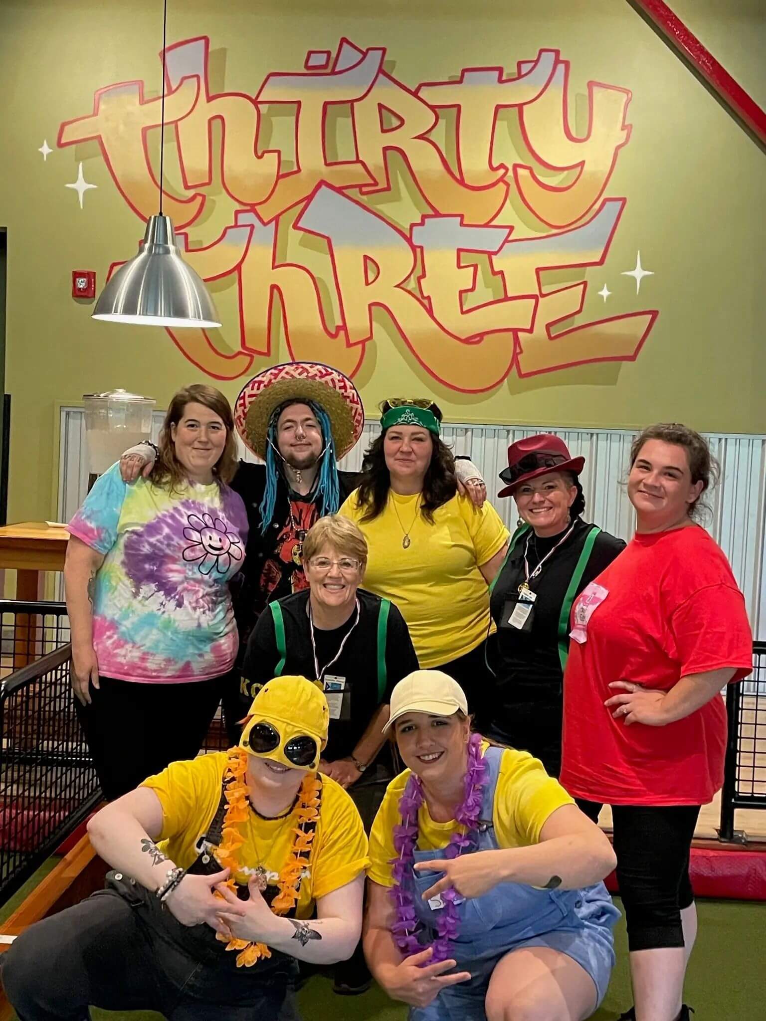 Hairstylists from Great Hair in Maine enjoying team corn hole night, highlighting strong employee culture and camaraderie.