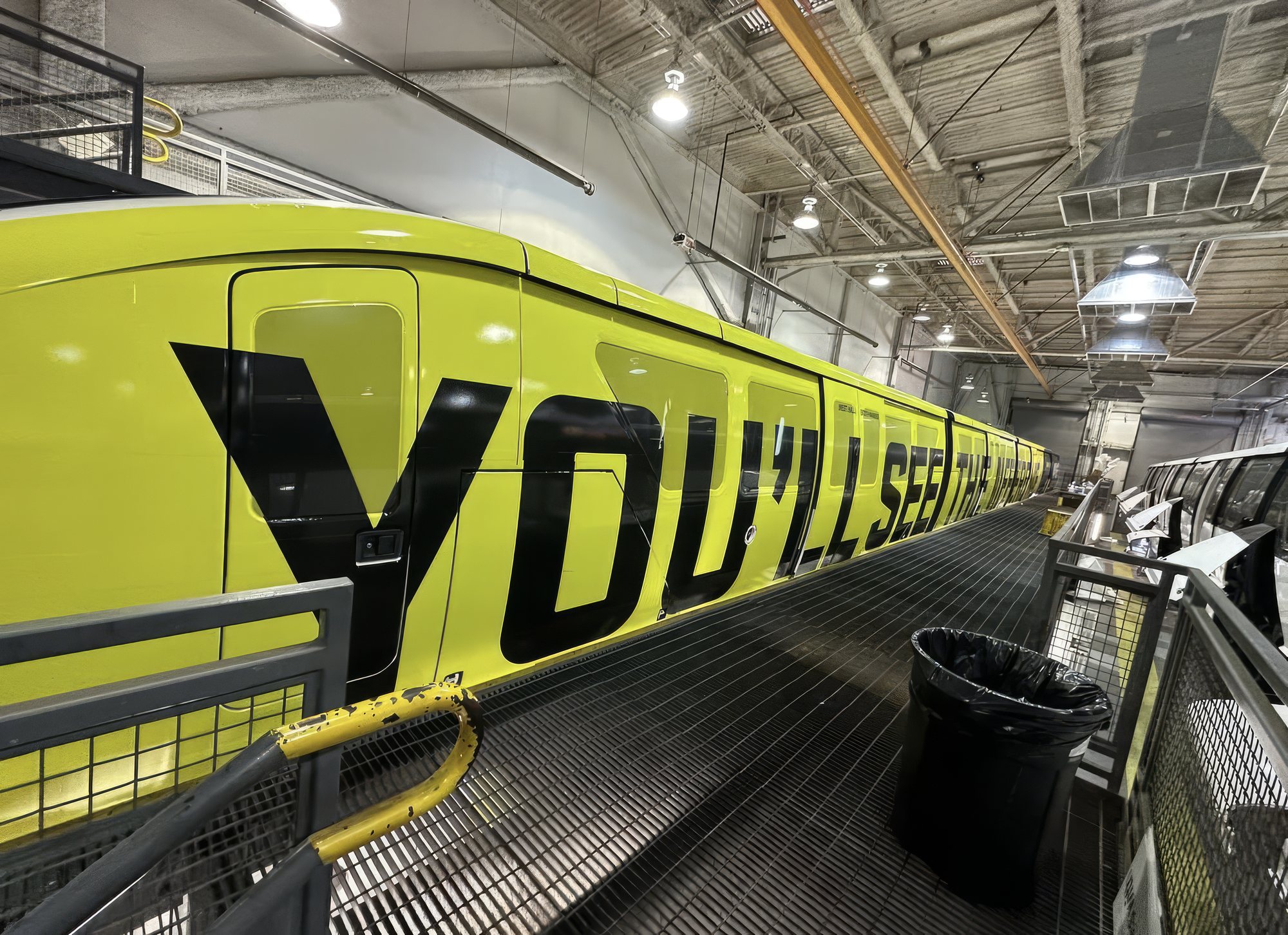 Neon monorail wrap: "You'll see us" vehicle graphics by Retail Print Group