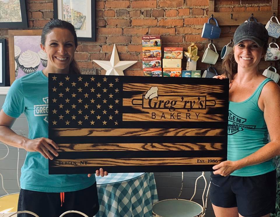 Laura Smith holding the Greg'ry's sign