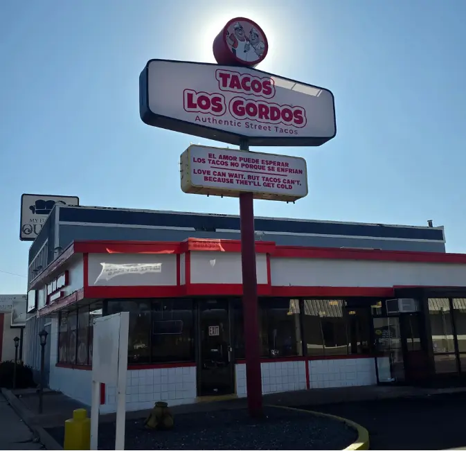 Tacos Los Gordos restaurant sign — Love can wait but tacos can't