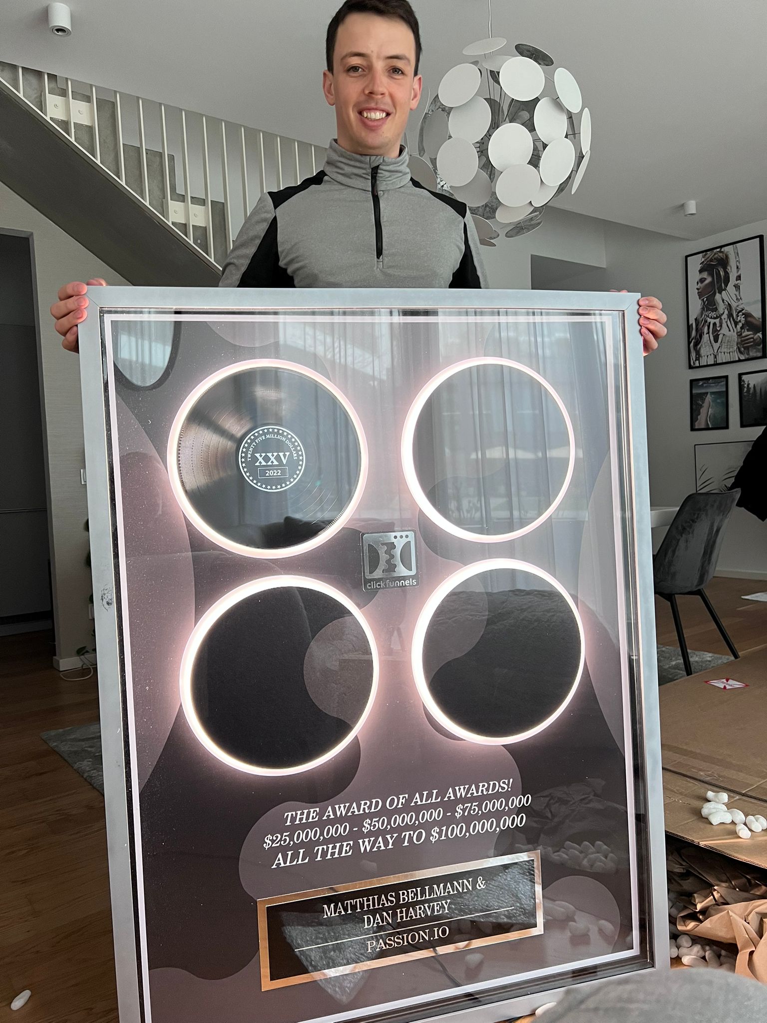 Dan Harvey holding the ClickFunnels award for Passion.io