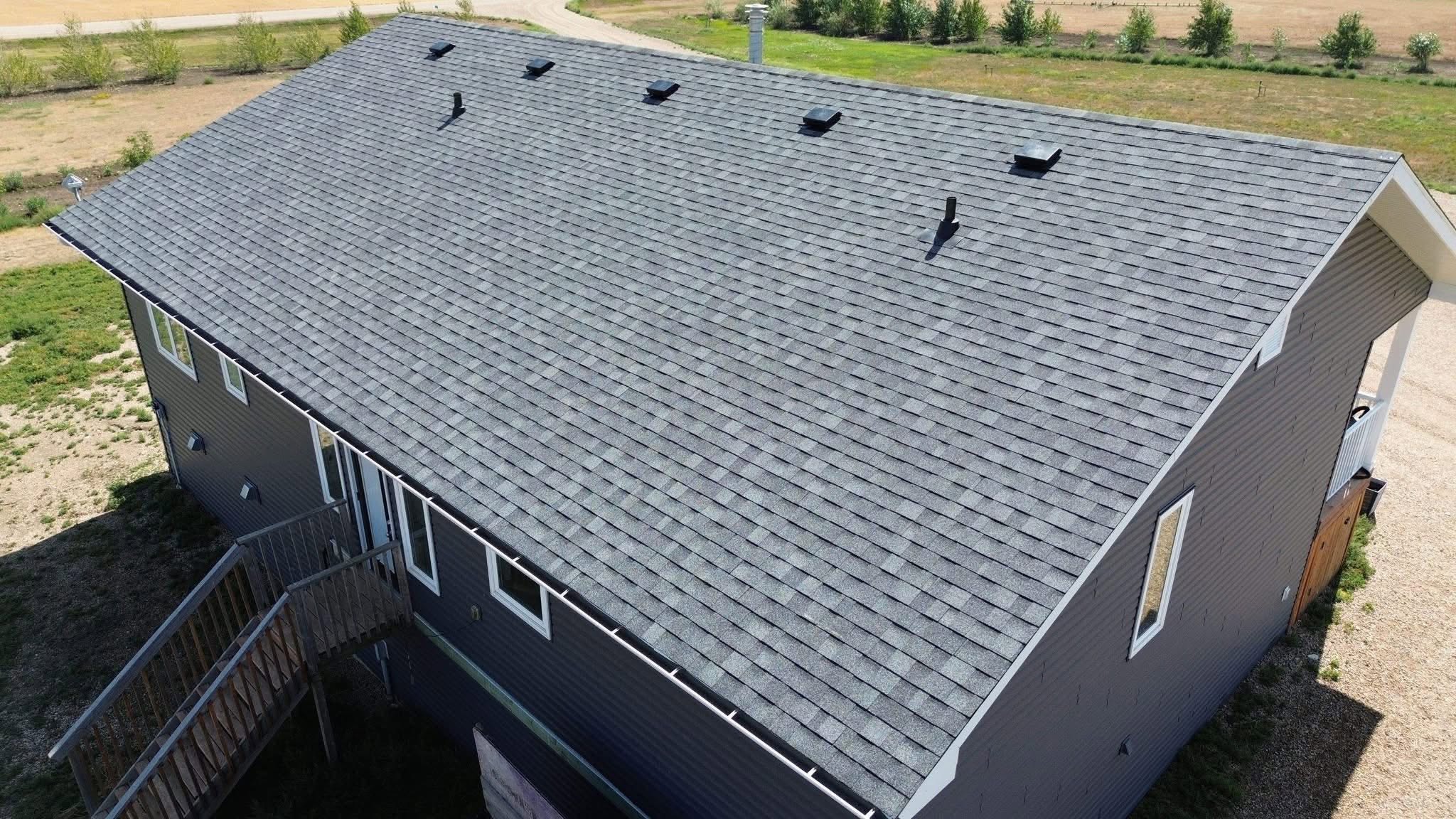 Shingle roof installation — clean roofline and flashing detail