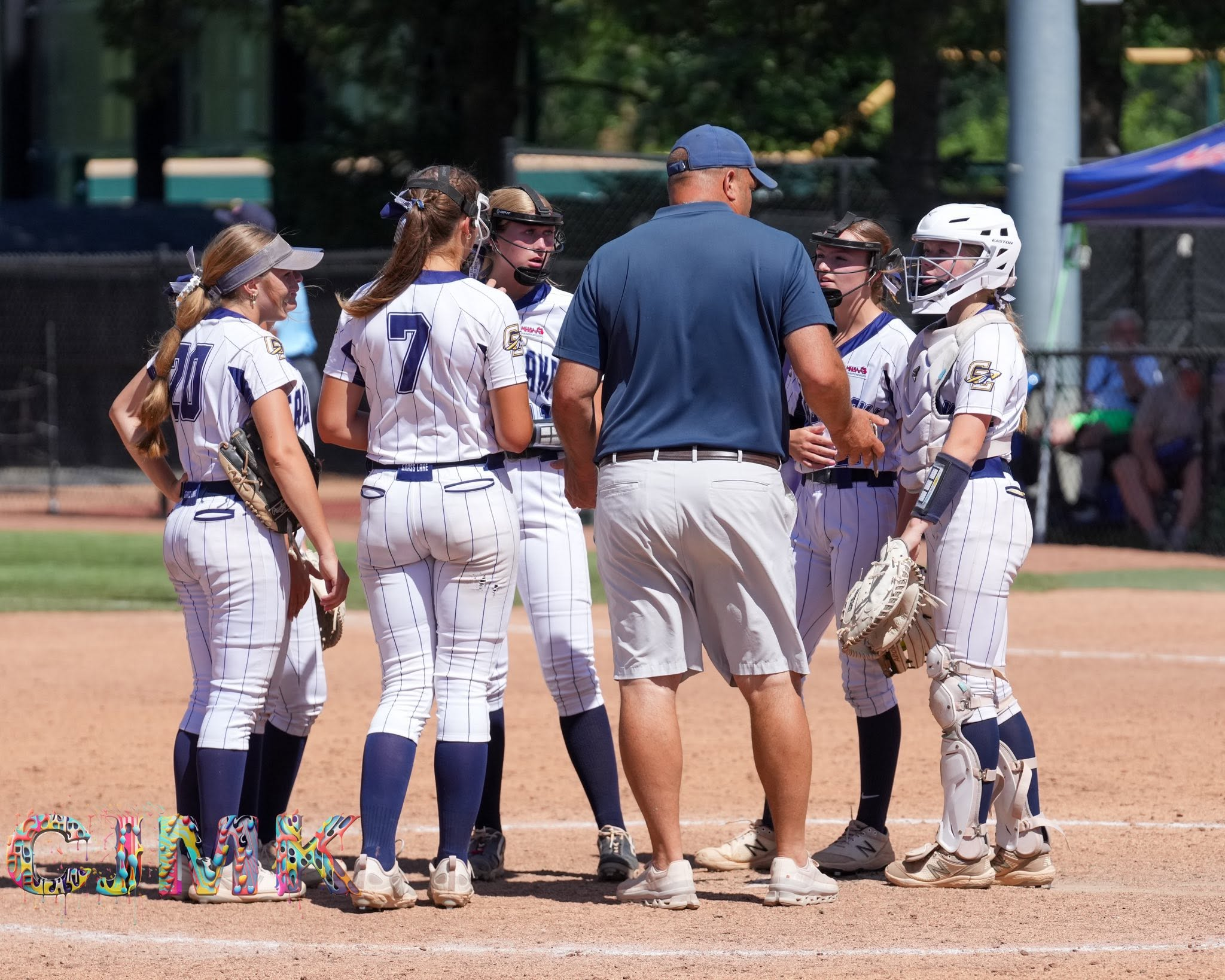 Coach Roger Cook huddles with the Warriors before the title game