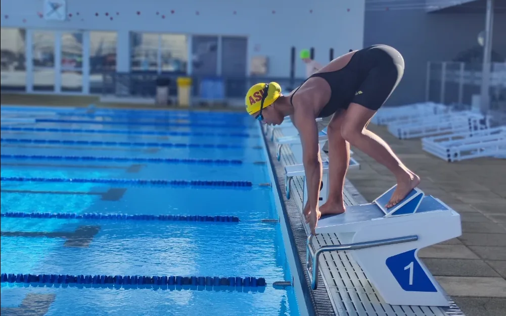 A competitive swimmer set on the starting block at the Swimpros camp in Tenerife