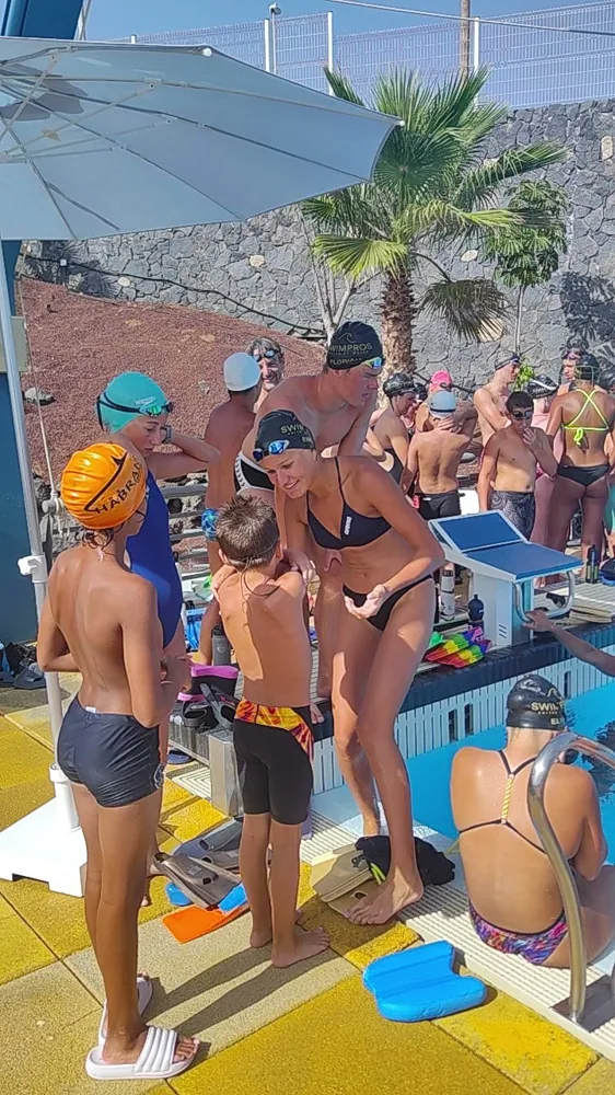 A coach talking two young swimmers through their set