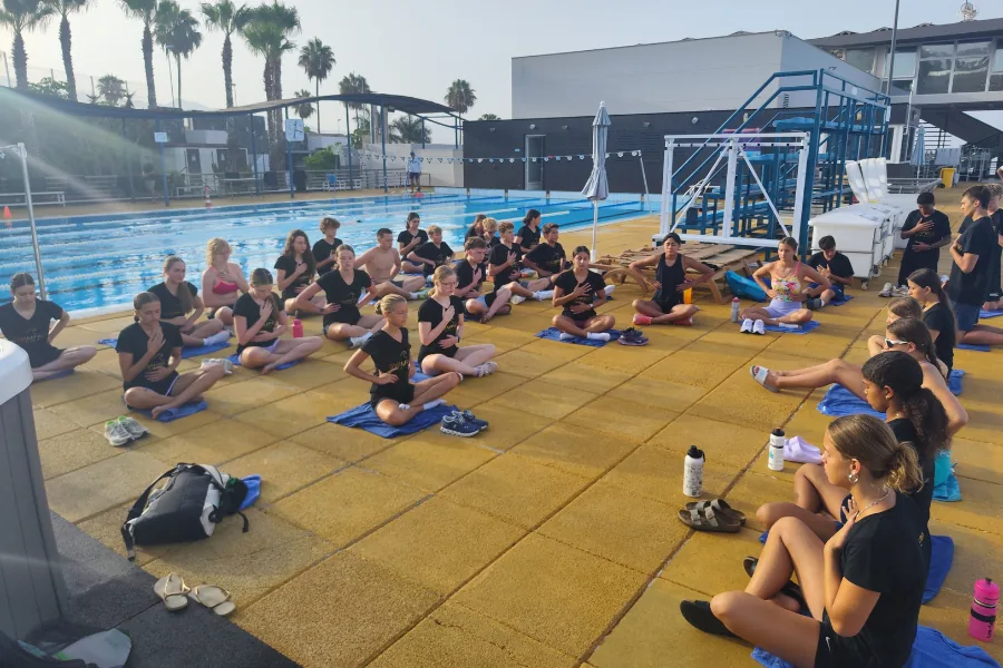 The squad seated poolside for a confidence session with David