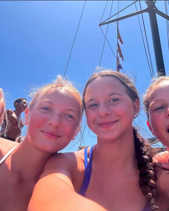 Swimmers smiling on the deck of the Swimpros boat trip off Tenerife