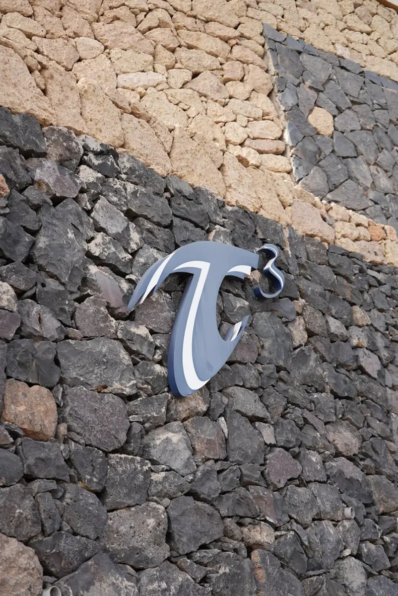 The T3 logo on the lava-stone wall