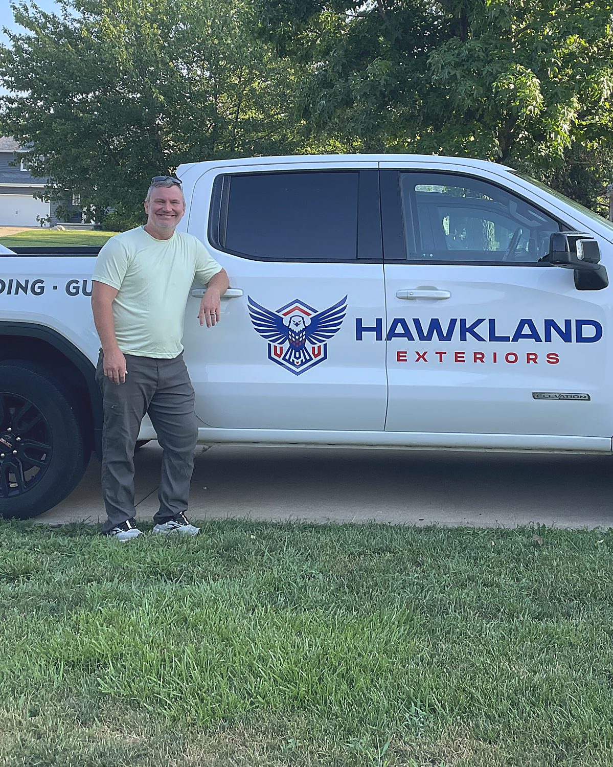 Tony Offerman, owner of Hawkland Exteriors, with his truck in Cedar Rapids IA