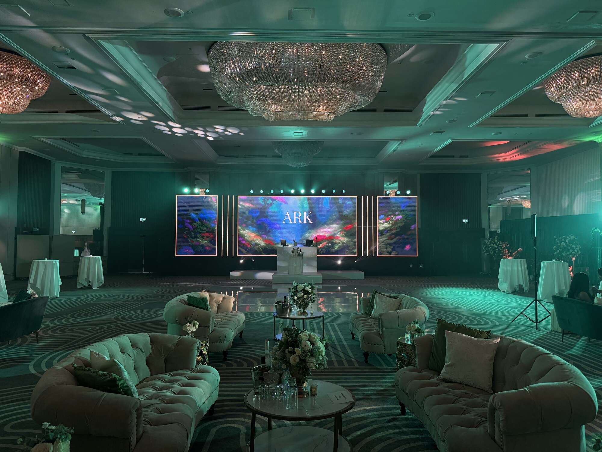 Reception room with LED screens, lounge furniture and uplighting