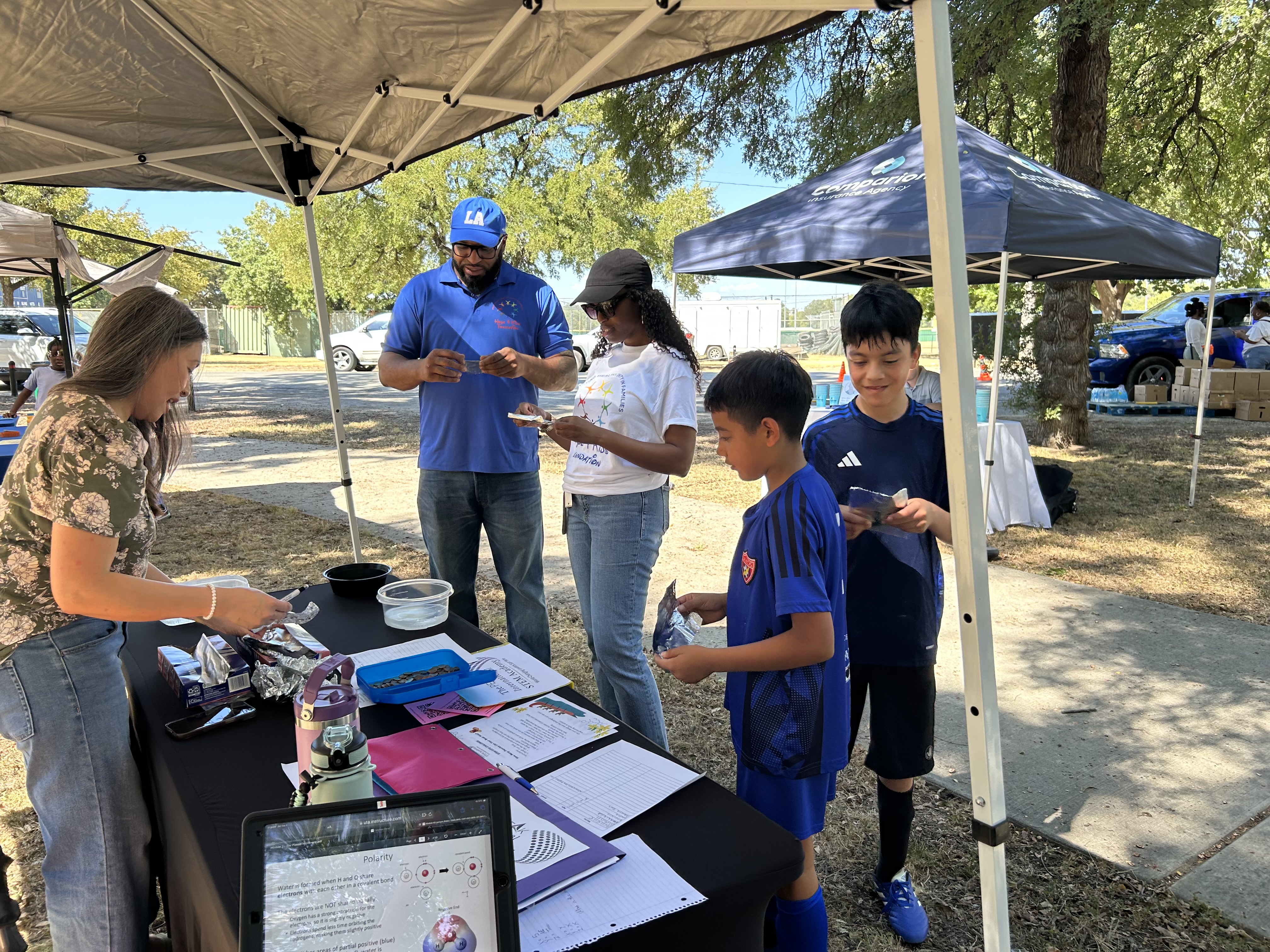Children receiving back-to-school resources at Sycamore Park, Sept 5, 2026