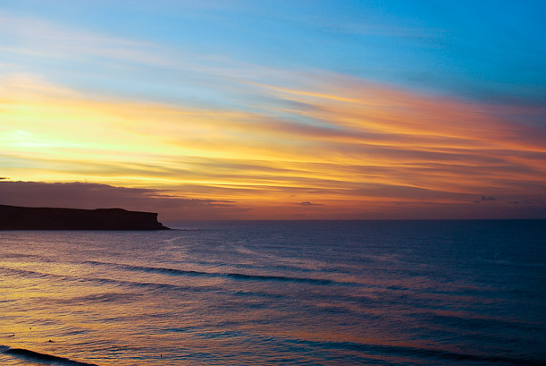Sunset over Los Locos. Surfing waves in Spain