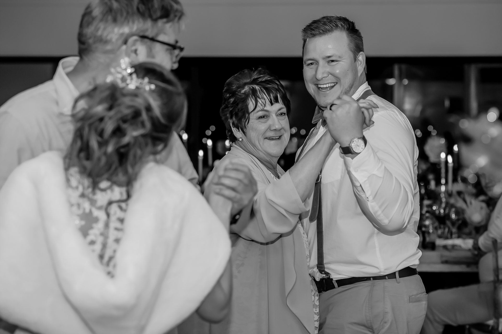 Wedding guests dancing together at the reception