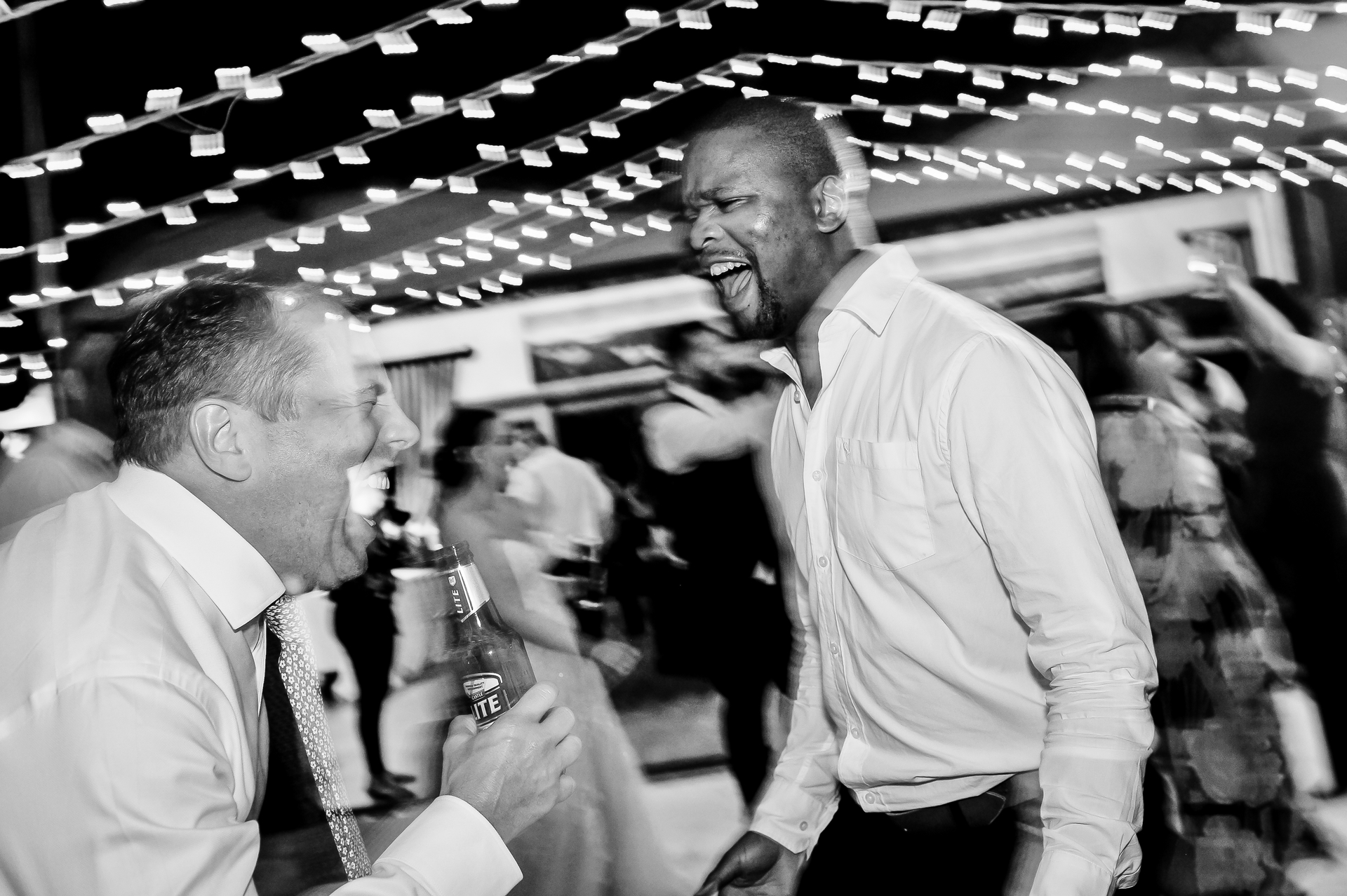 Two men laughing on the dance floor