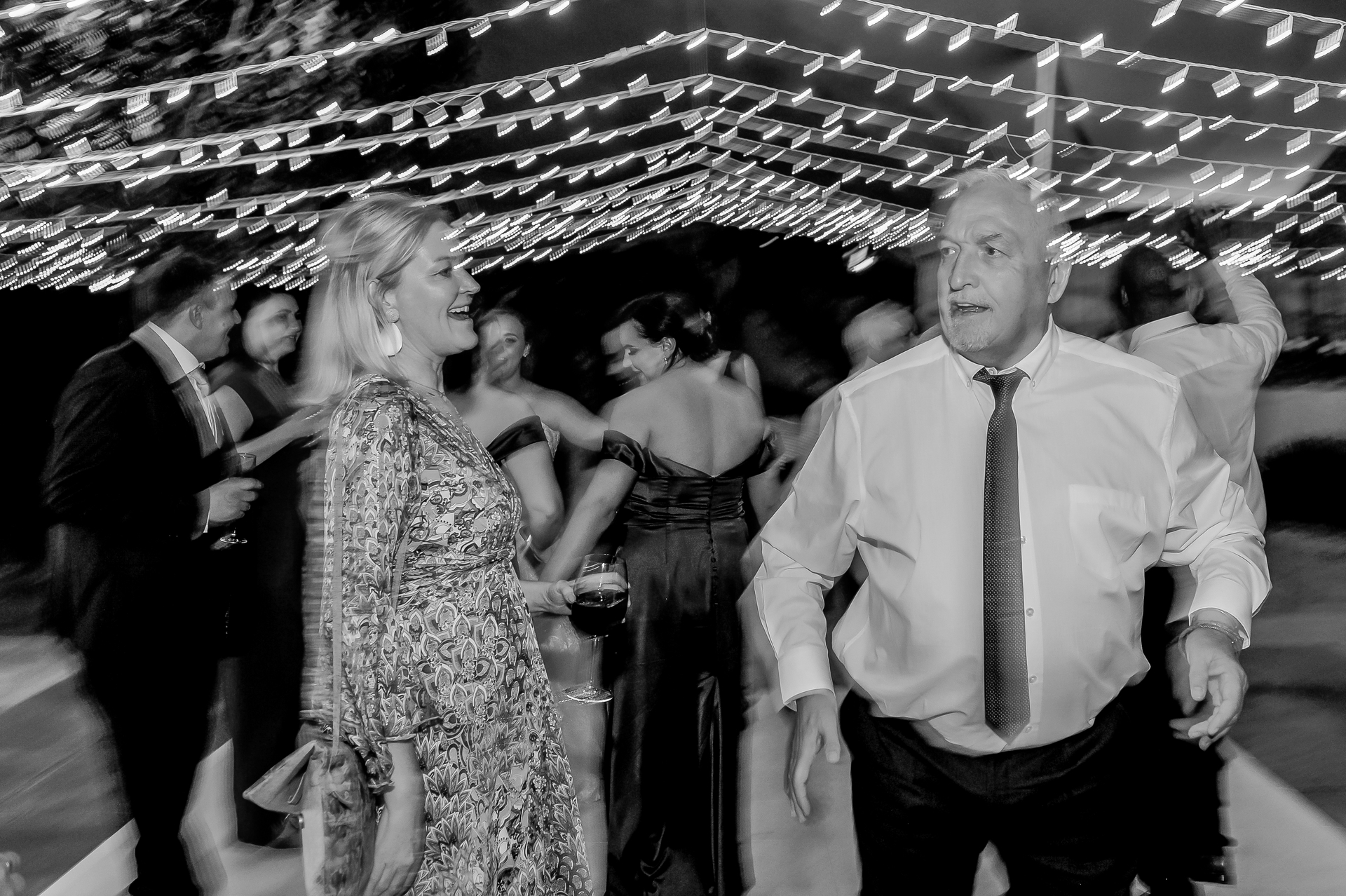 Guests dancing under strings of fairy lights