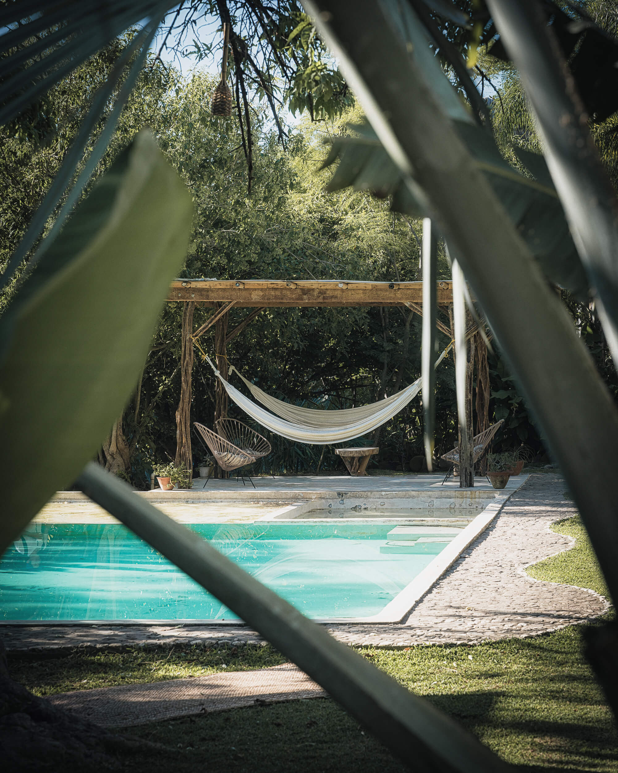 Tropical pool and hammock area surrounded by greenery at Amate Retreat Centre