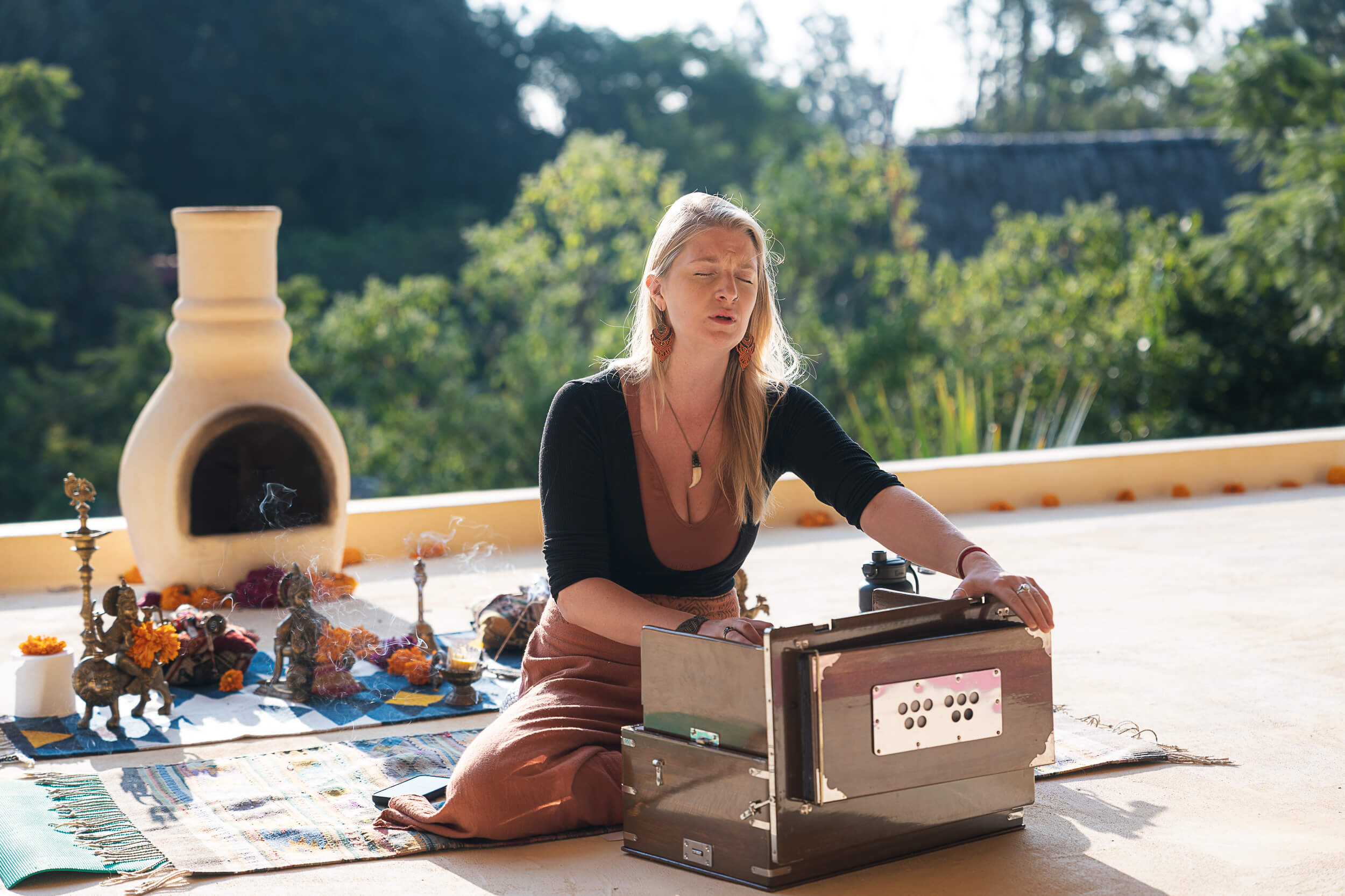 Harmonium player leading a sound healing session on the terrace at Amate Retreat Centre