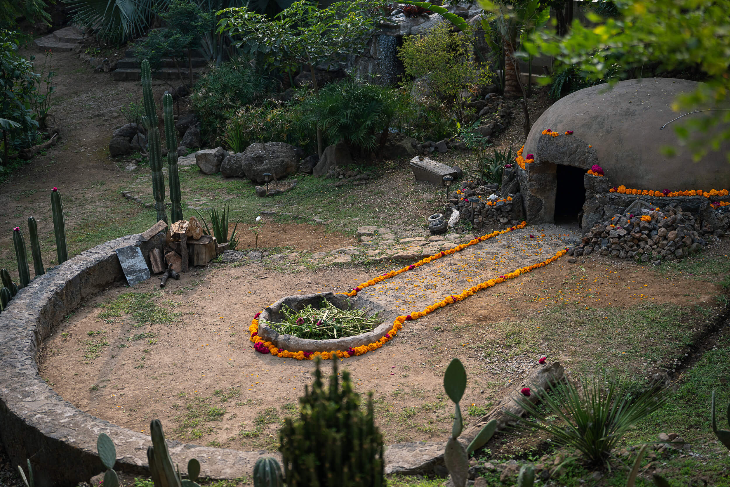 Traditional temazcal structure decorated with marigold petals for ceremonies at Amate Retreat Centre