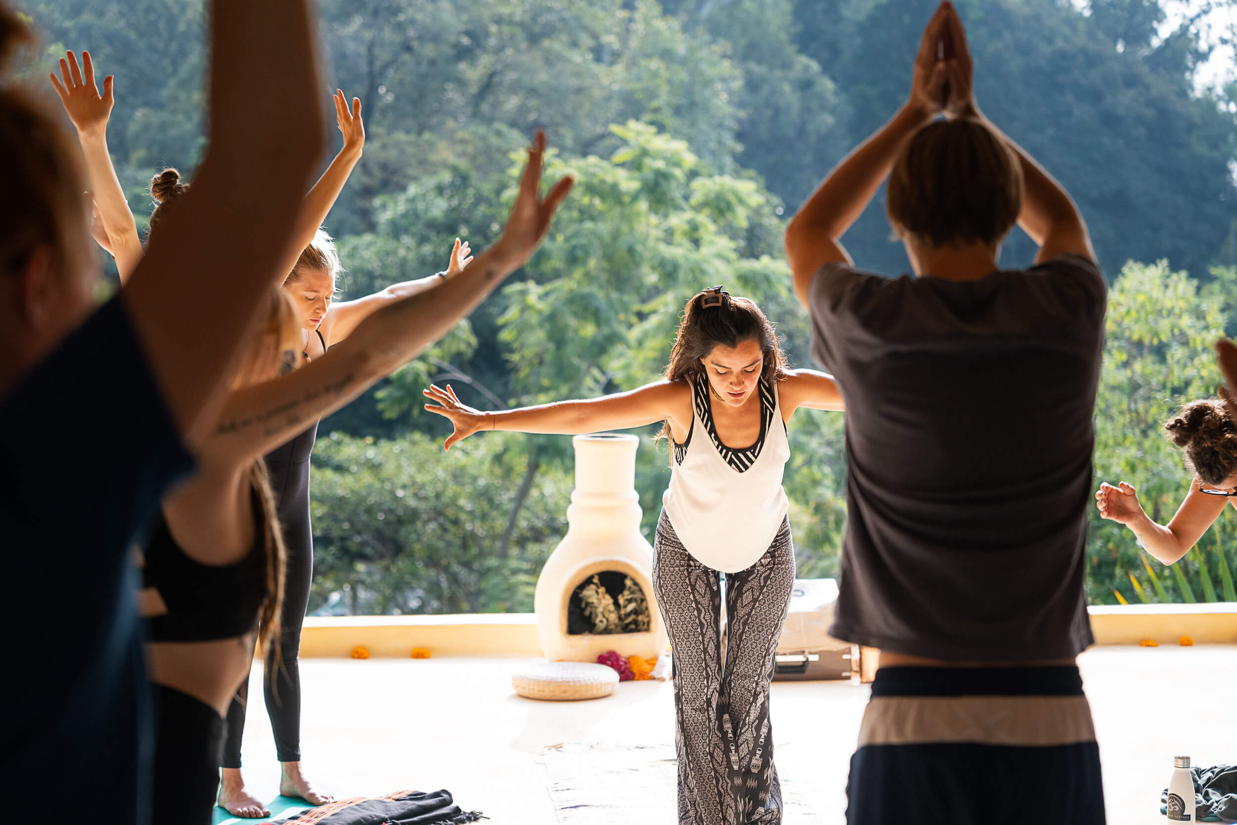 Morning yoga session with participants stretching in the open-air terrace at Amate Retreat Centre