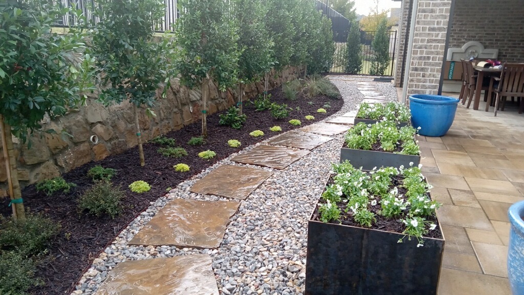Landscape design with flagstone path, gravel, planter boxes and stone retaining wall — Aeroscapes Landscaping Allen TX