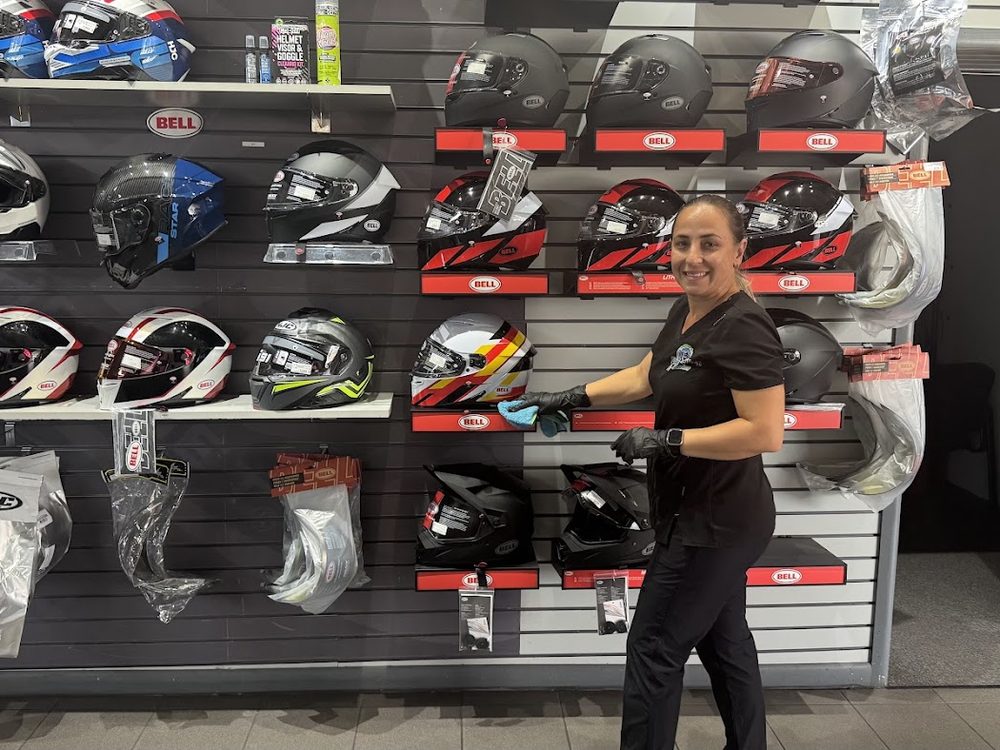 A Floor 2 Ceiling team member cleaning a motorcycle dealership