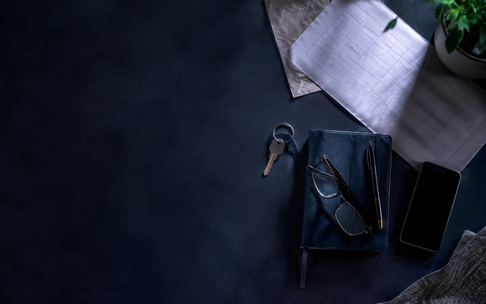 Illustrative household desk with a key, school planner, papers, and phone