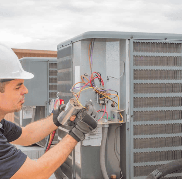 Experienced HVAC technician repairing an heat pump unit in PortCoquitlam