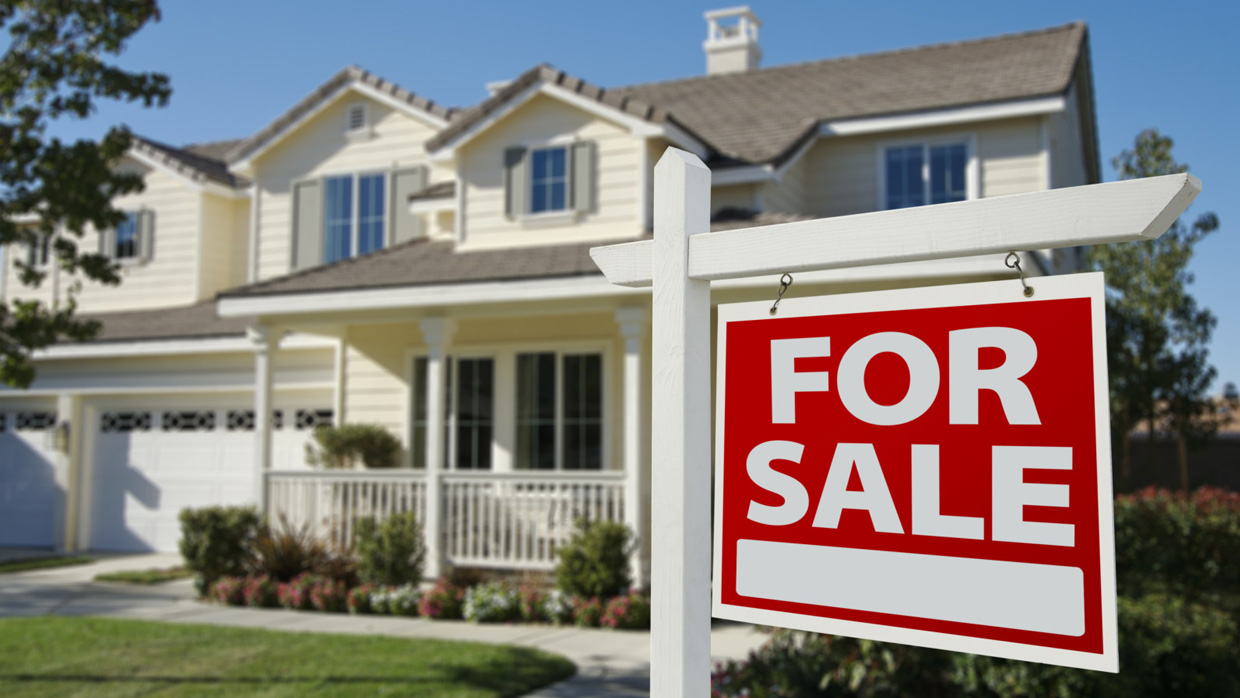 Family reviewing financial documents to decide between renovating or selling home as-is in DFW