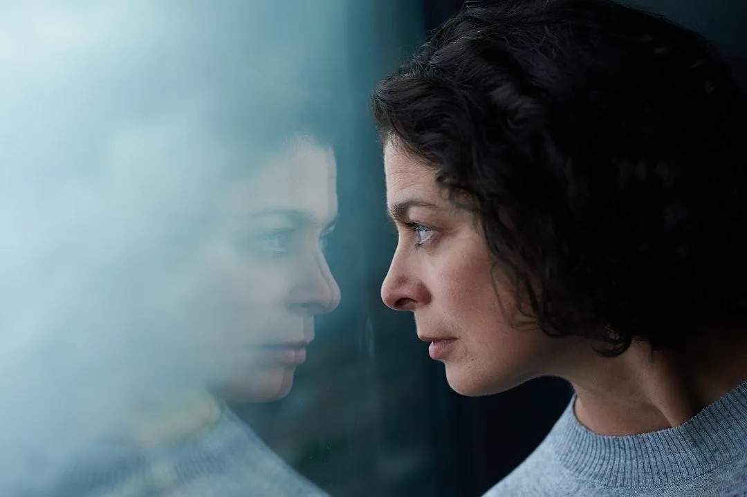 woman looking out the window of a car