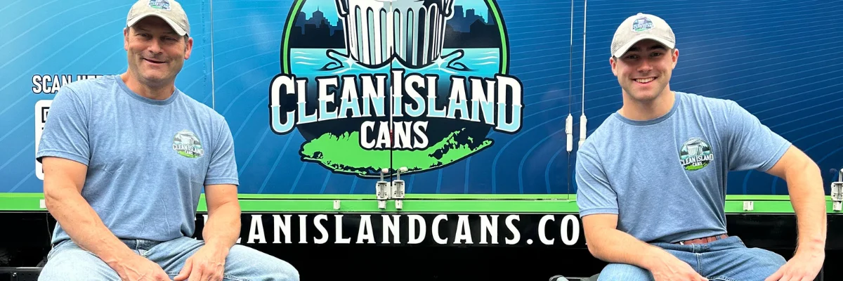 Clean Island Cans team members sitting in front of branded bin cleaning truck.
