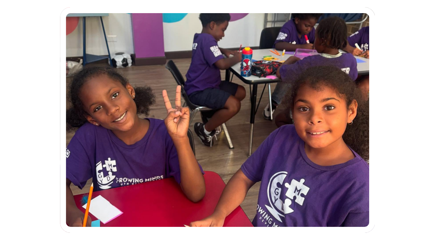 children in purple shirts smiling