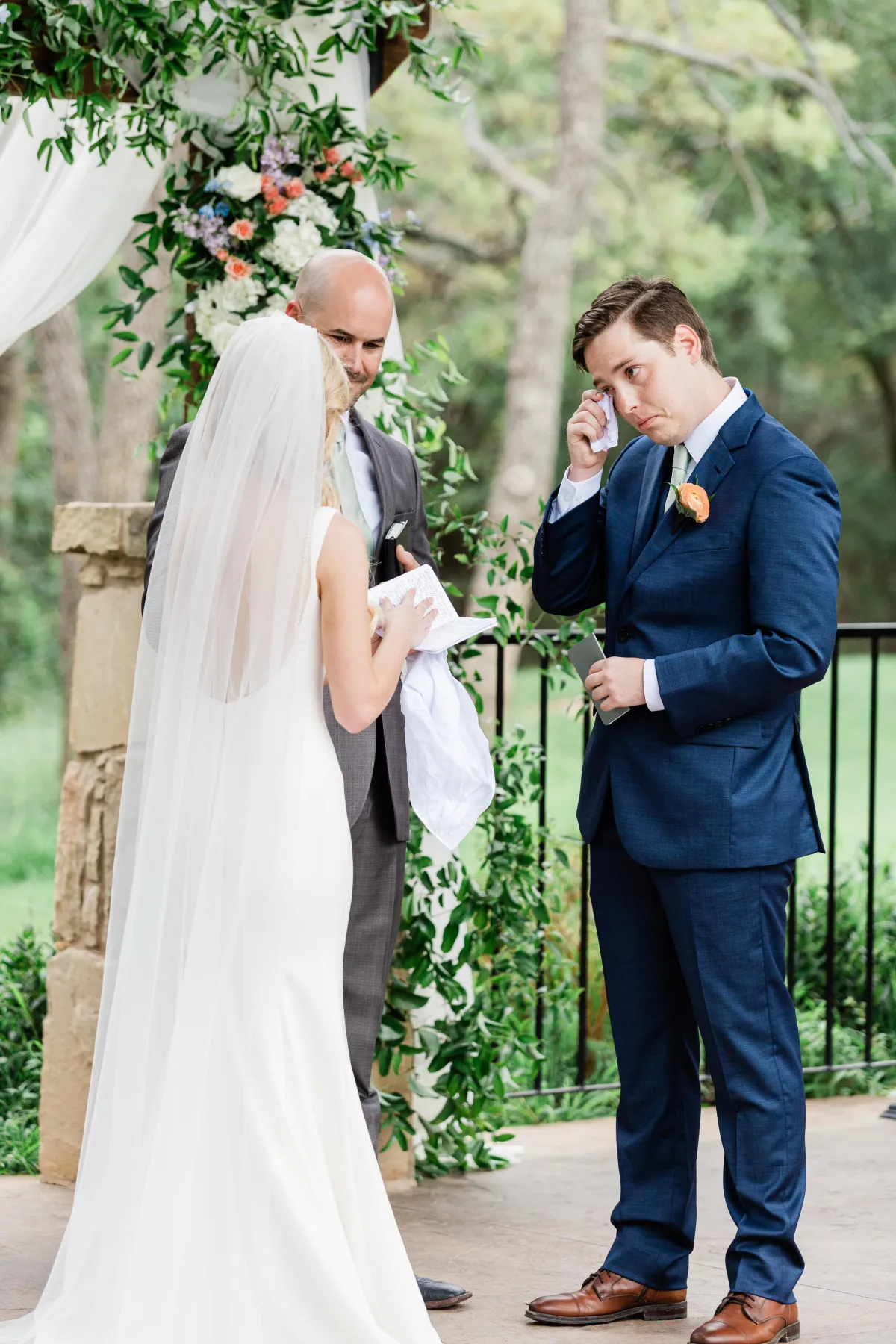 Emotional groom wiping tears during ceremony vows, captured by a DFW wedding photographer.