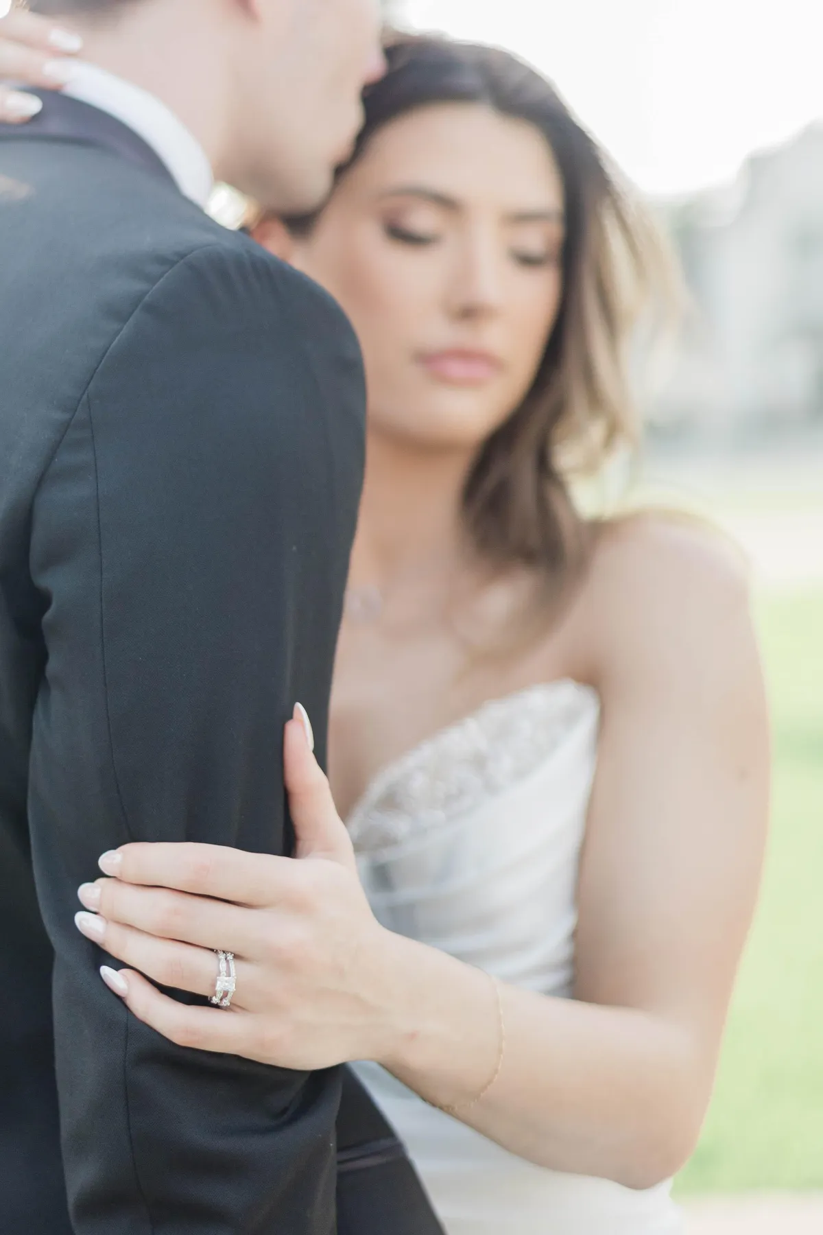 Close-up bridal portrait with engagement ring detail and refined editorial wedding photography style.