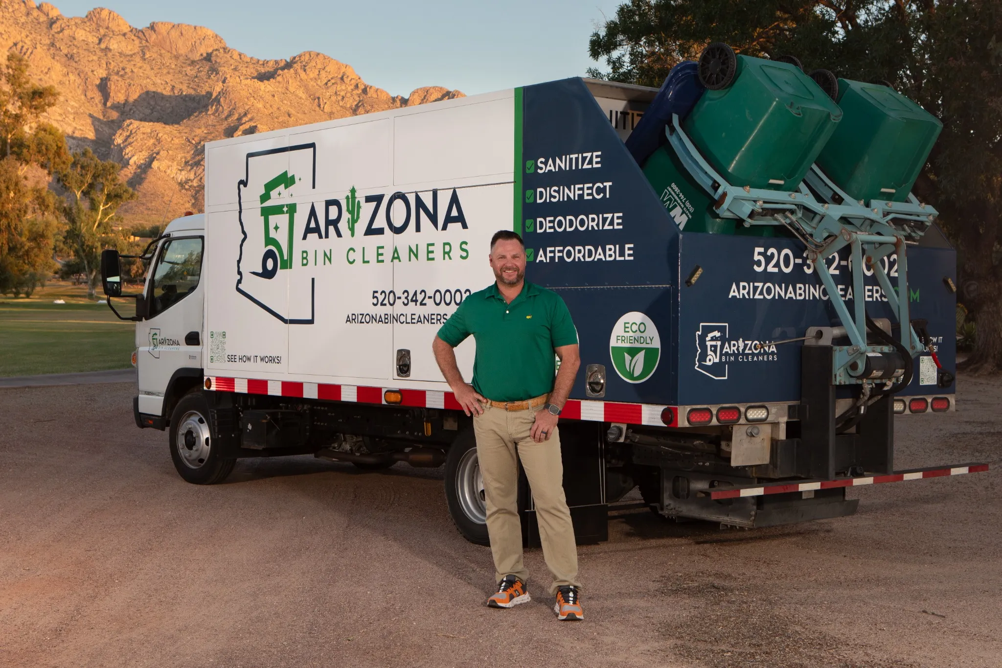 Owner of Arizona Bin Cleaners standing proudly in front of eco-friendly trash bin cleaning truck in Tucson, AZ. 