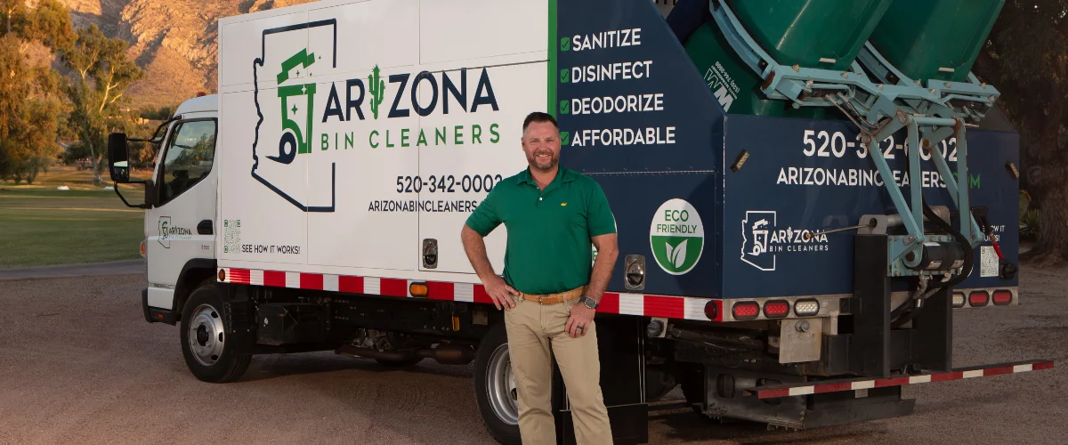 A white Arizona Bin Cleaners truck parked in a residential area, with a green trash bin partially visible behind it.