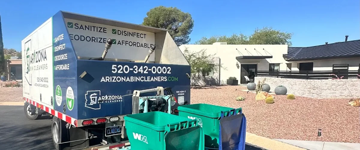 A white Arizona Bin Cleaners truck with green branding parked under palm trees on a sunny day.