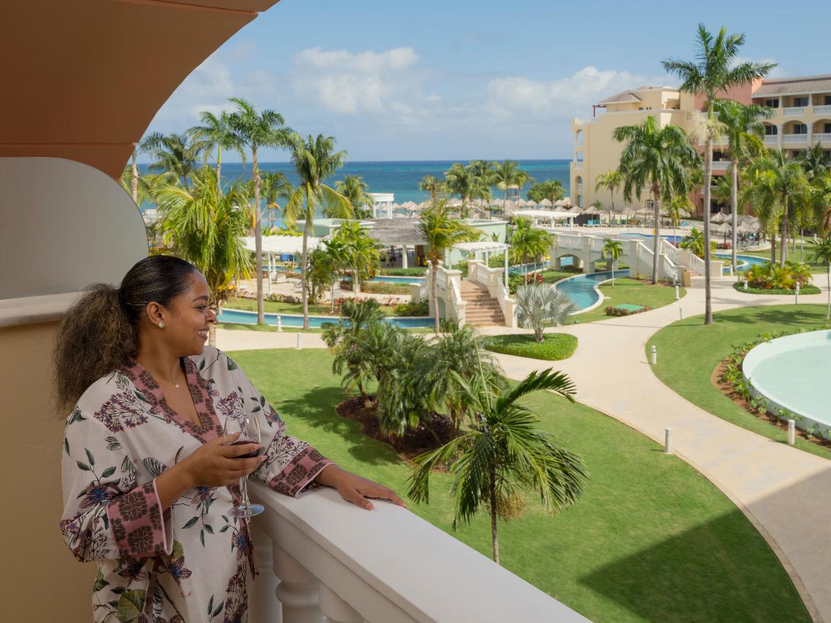 Woman in the resort holding wine glass bottle