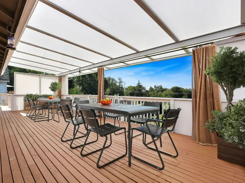  Solid patio cover with a cedar tongue-and-groove ceiling and timber trusses over a composite deck