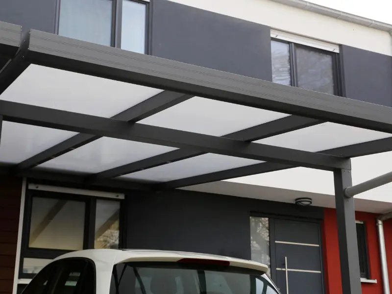 Aluminum carport covering parked car at home. Aluminum carport covering parked car at home.