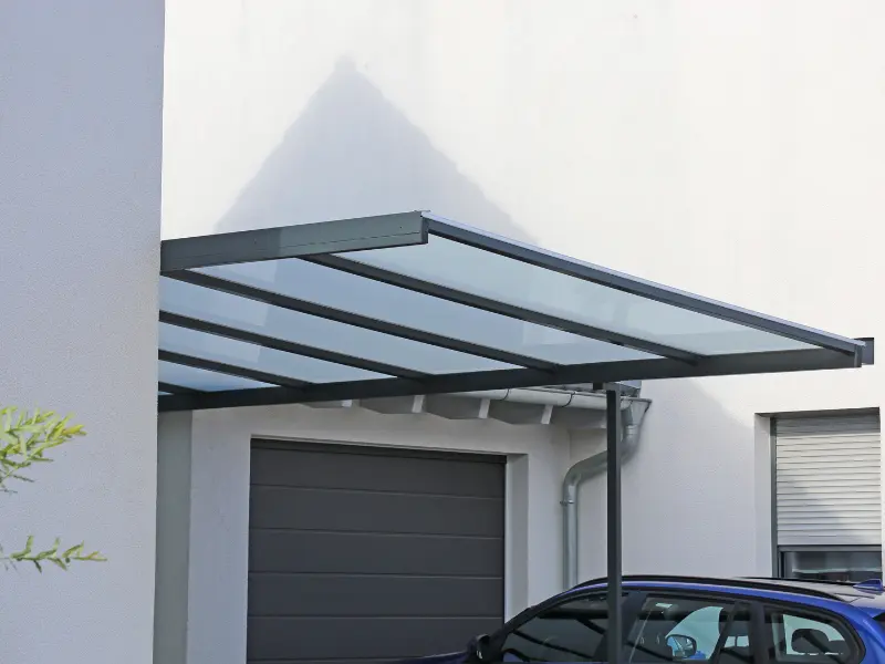 Aluminum carport attached to home over garage. Aluminum carport attached to home over garage.
