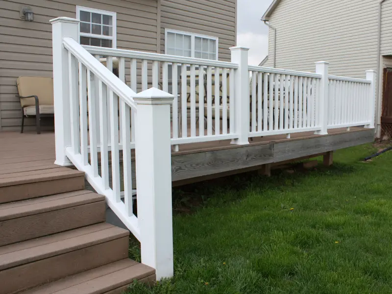 Multi-level deck with white vinyl railing and connecting stairs.