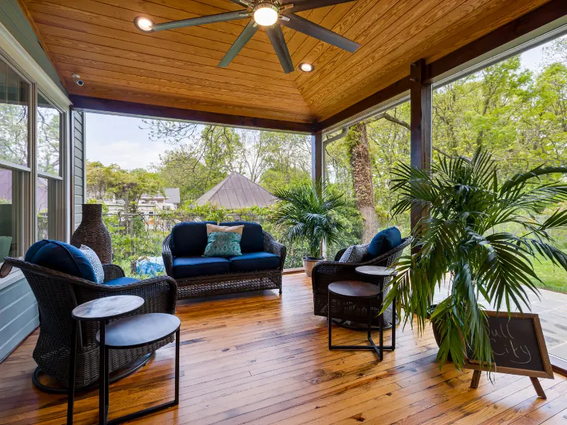 Patio cover with a stained wood ceiling, recessed lights, and a ceiling fan over a screened porch.
