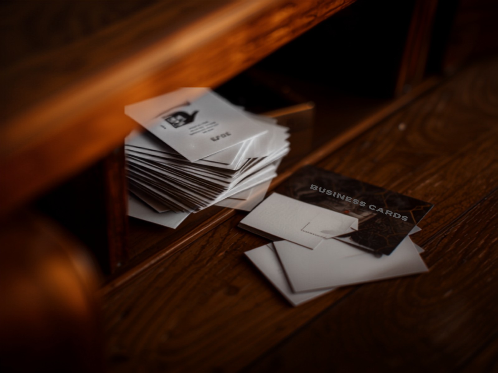 A forgotten stack of business cards in a desk drawer weeks after a networking event
