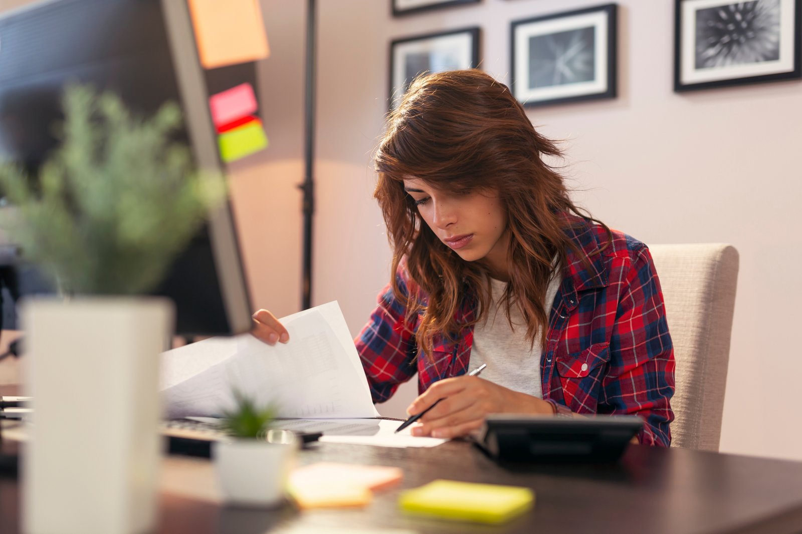 Reading loan documents at a desk at home
