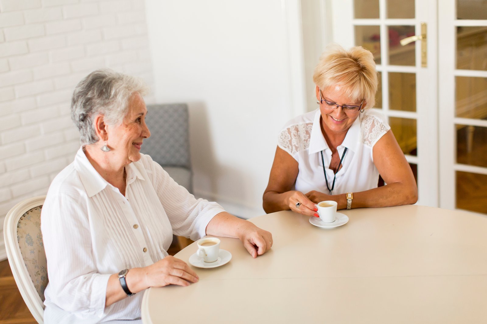 Two people talking through a decision over coffee at home