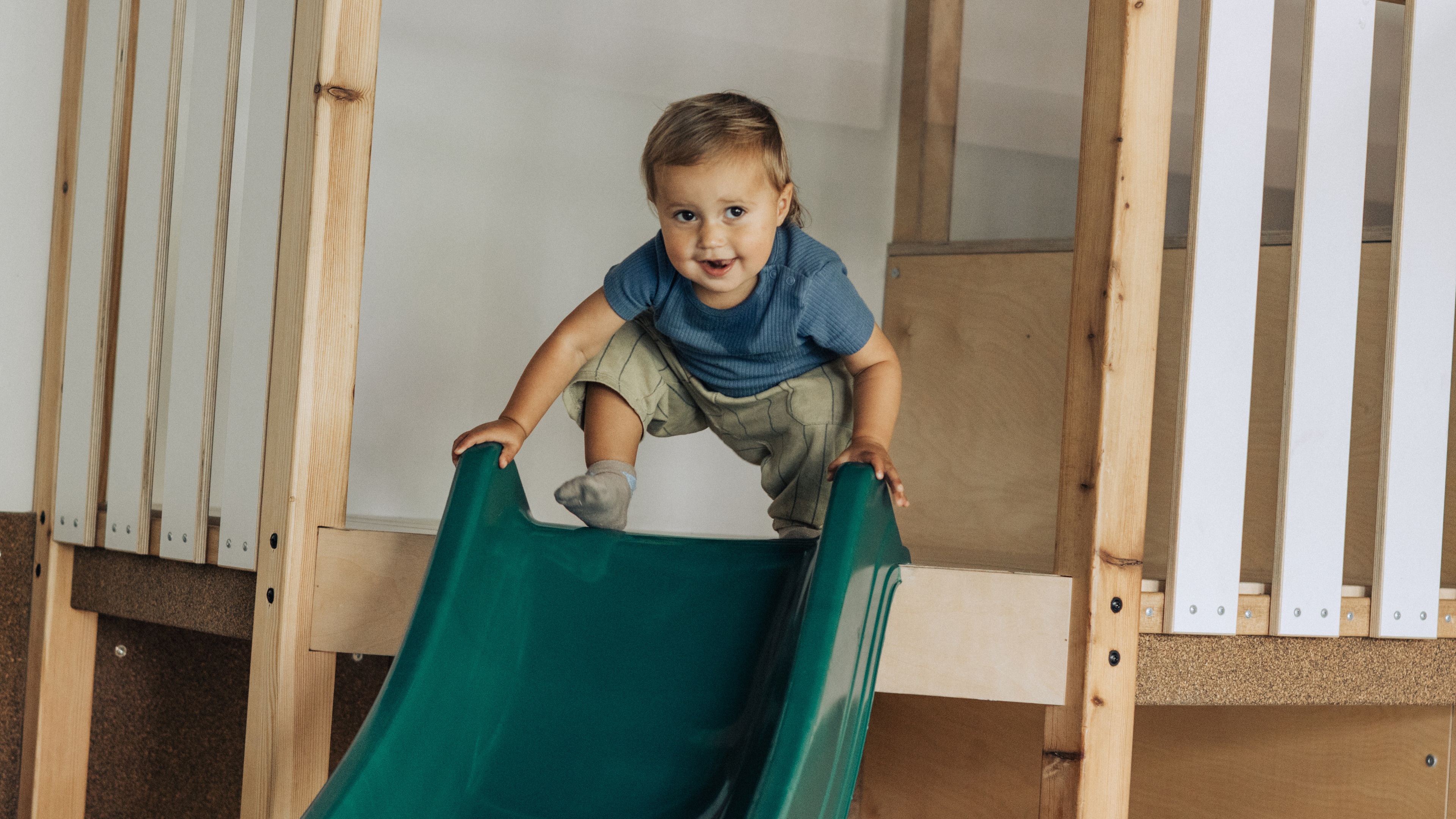 Young girl kneading dough in a kitchen.